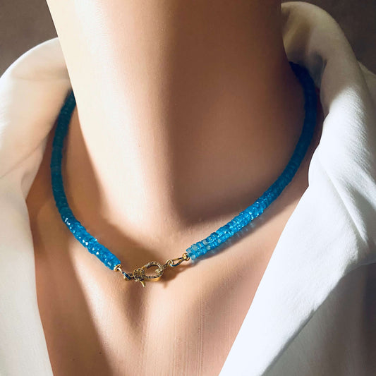 Blue topaz beaded necklace showcasing vibrant neon blue beads and a gold vermeil pavé clasp, elegantly displayed on a mannequin.
