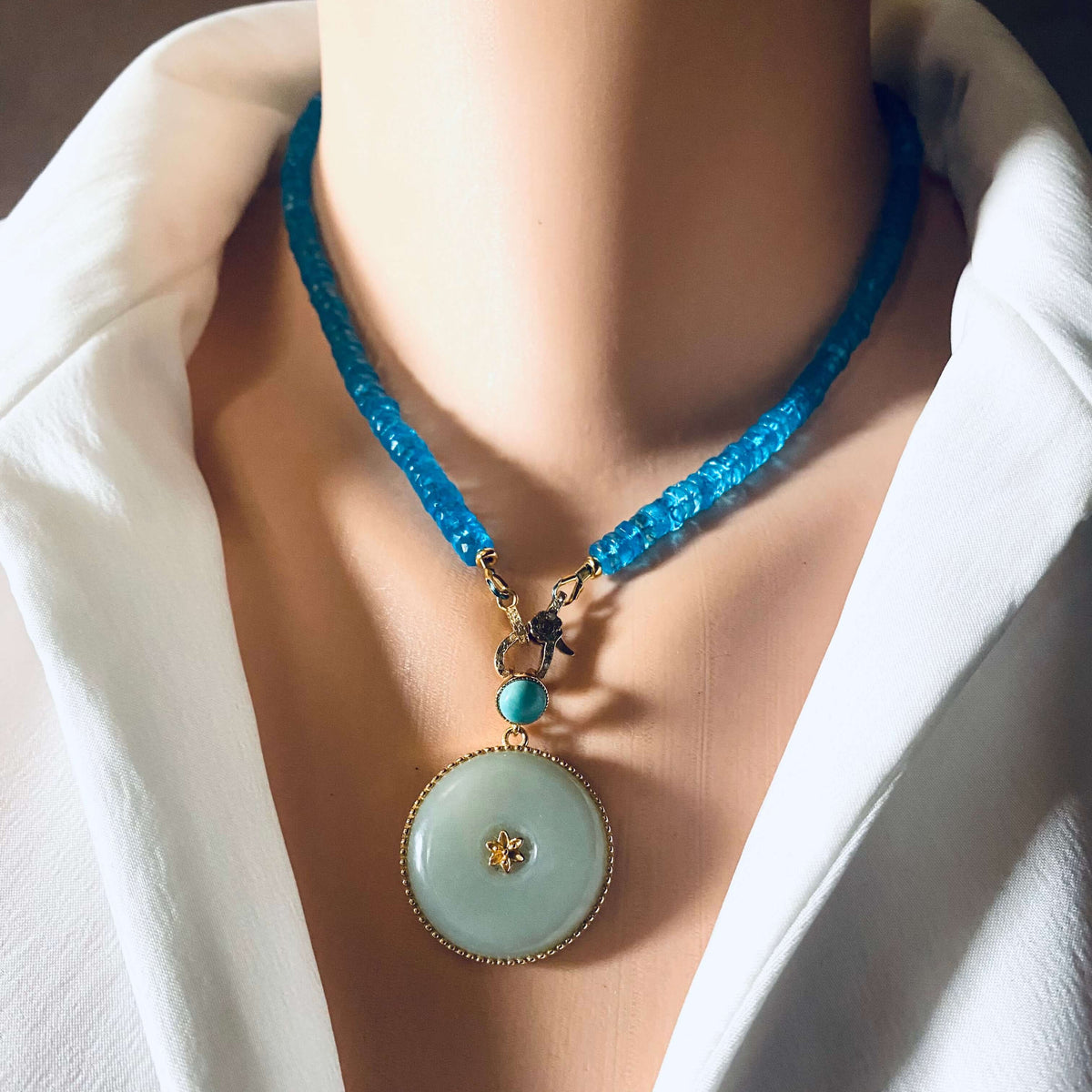 Blue topaz beaded necklace with gold vermeil pavé clasp worn by a mannequin, showcasing vibrant color and elegance.