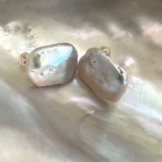 Baroque pearl stud earrings with white rectangular freshwater pearls on white shell, showing natural luster and handcrafted finish.