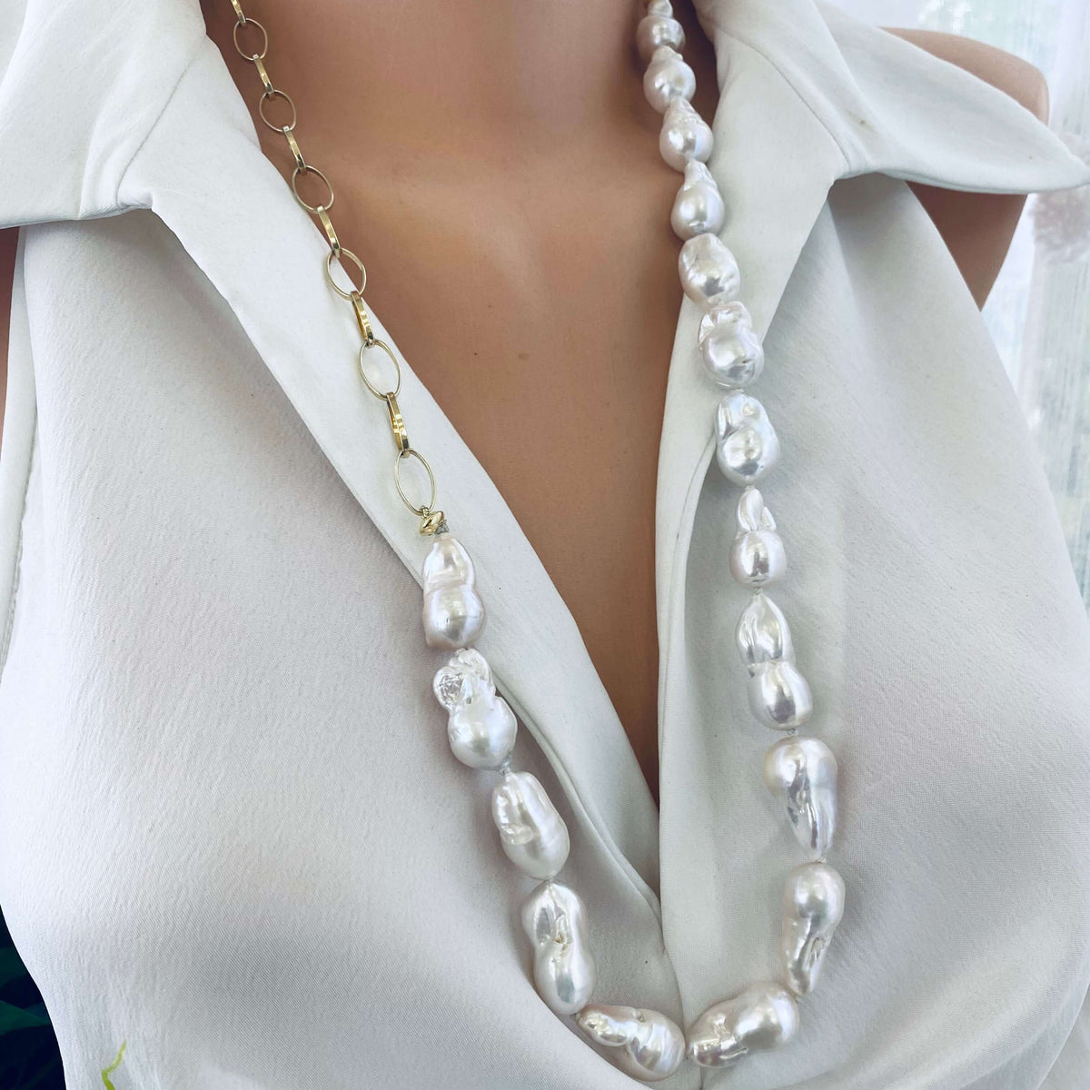 Side view of baroque pearl gold chain necklace on mannequin — elegant handcrafted pearl and gold necklace design by Loulia Pearl Jewelry