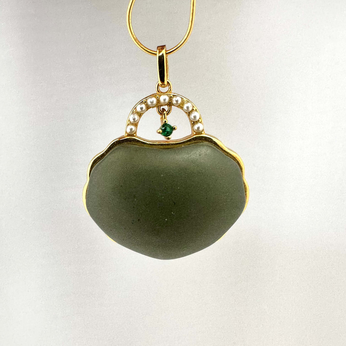 Hotan jade purse pendant with pearl detail in gold vermeil, showcasing a miniature purse design with a calming green tone.