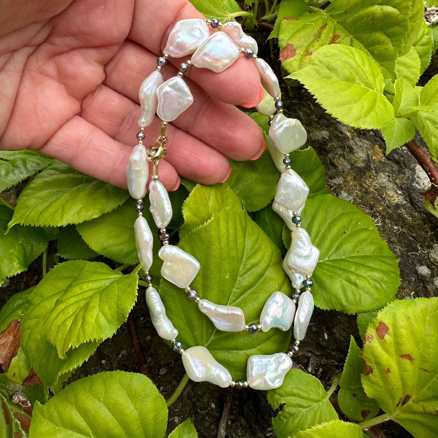 Black and White Pearl Necklace with diamond-shaped pearls – natural light foliage shot