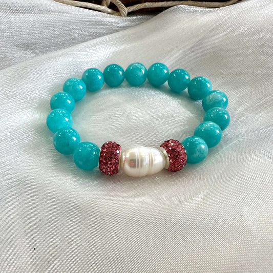 Teal jade bracelet featuring natural 10mm jade beads, freshwater pearl, and pink rhinestone accents.