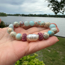 Load image into Gallery viewer, Add a touch of elegance and sparkle to your wrist with this stunning pale blue sediment Jasper and Freshwater Pearl Stretchy Bracelet, adorned with shimmering pink rhinestones for a touch of glamour