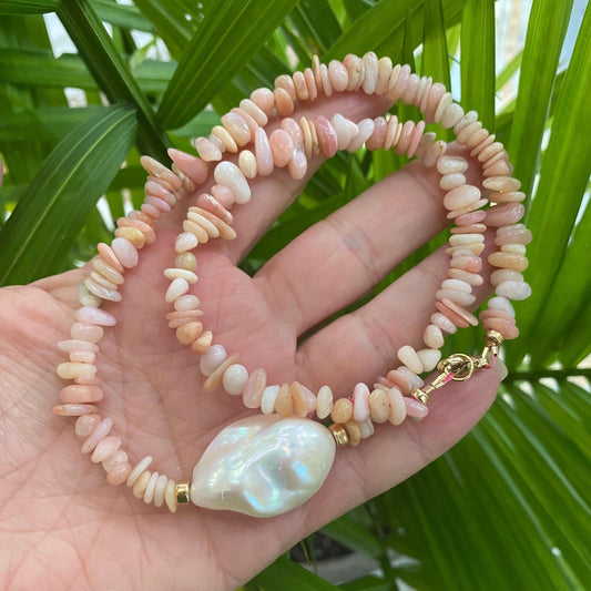 Pink opal pearl necklace held in hand
