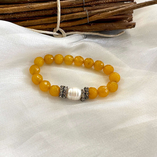 Yellow jade pearl bracelet displayed on white cloth