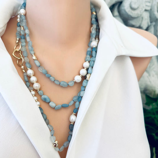 Aquamarine and pearl necklace styled in three layered strands on mannequin
