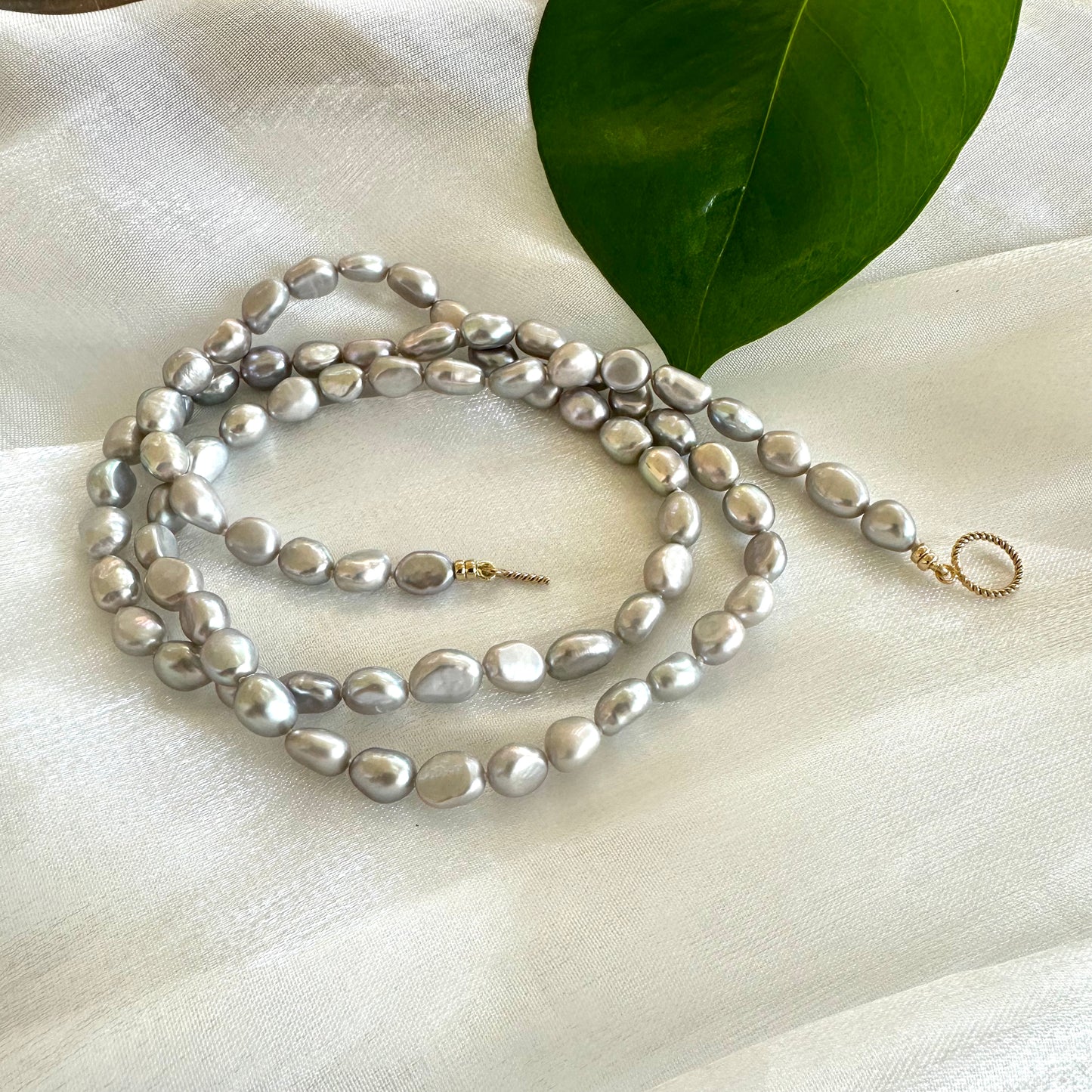 Grey nugget pearl necklace – 14K gold filled with organic beauty on a soft fabric background.