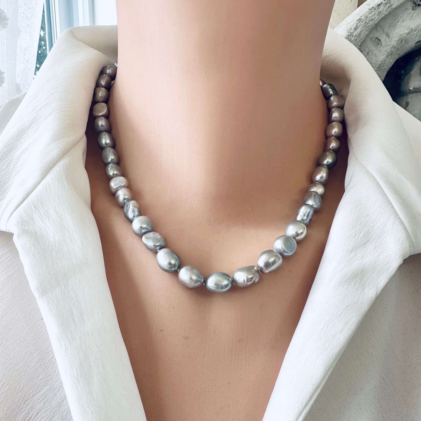 Grey pearl necklace showcasing silver-grey freshwater nugget pearls, emitting elegance and sophistication.