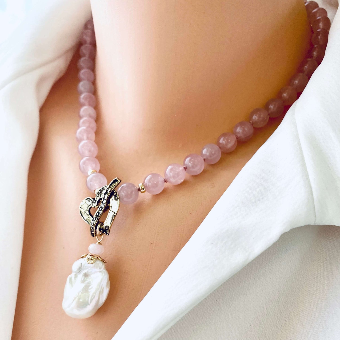 Rose quartz pearl necklace on mannequin showing baroque pearl pendant