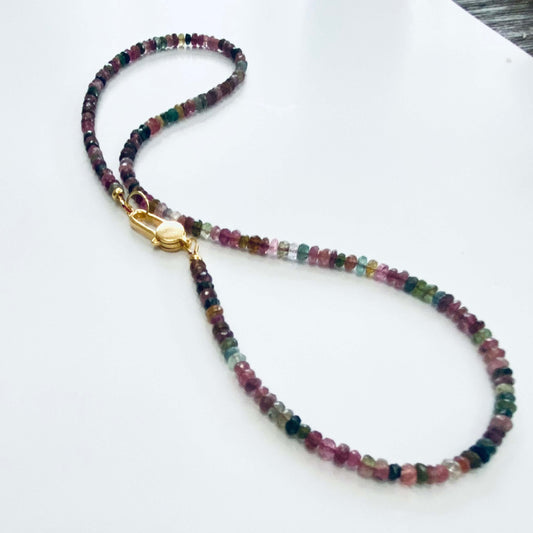Watermelon tourmaline necklace displayed on white cloth