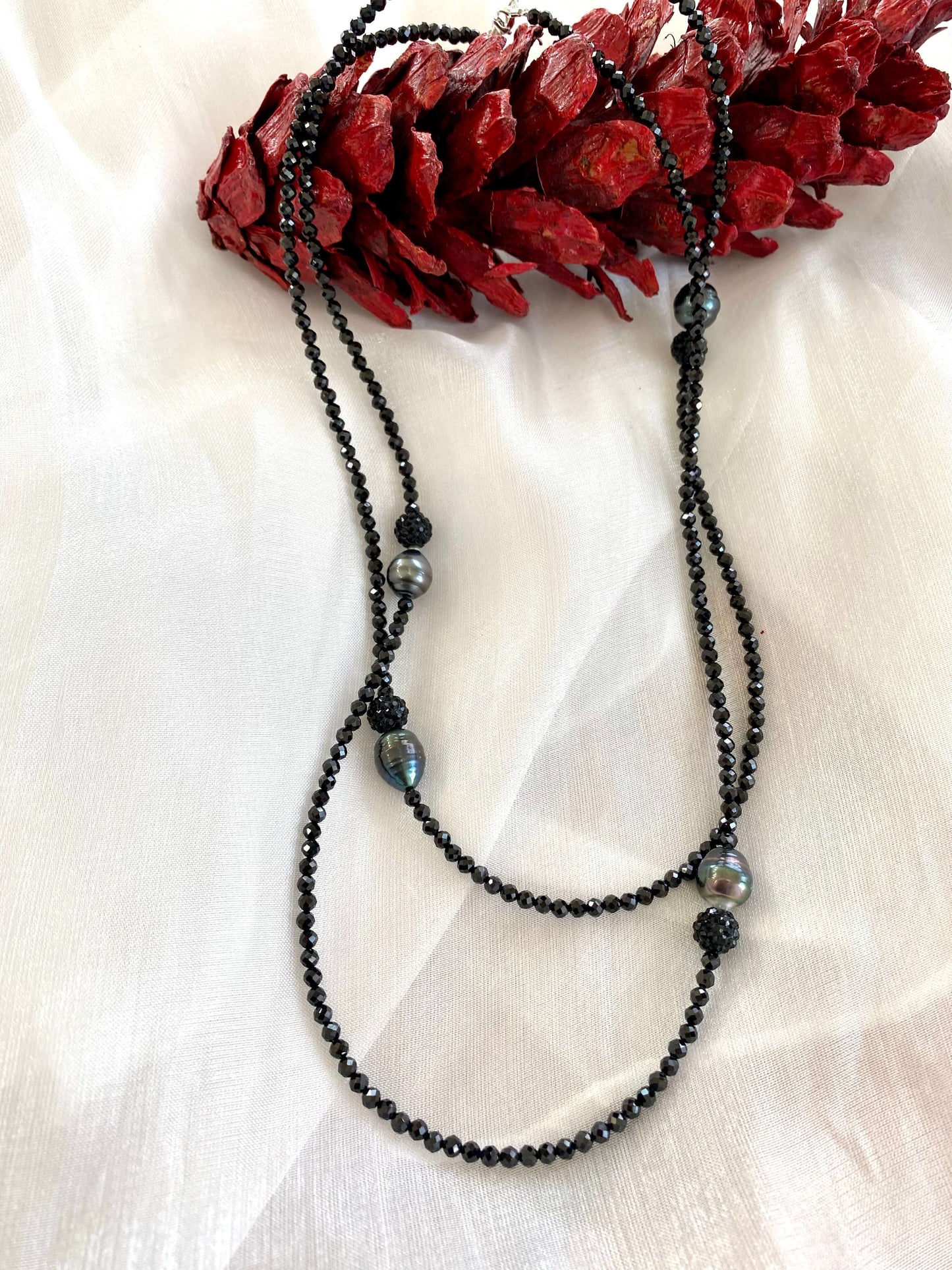 Black spinel pearl necklace on mannequin, close-up gemstone view