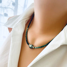 Load image into Gallery viewer, Stunning shaded green Necklace featuring faceted Emerald roundelle beads and a greenish black Tahitian Pearl centerpiece. May birthstone Gift For Her. Crafted with gold filled, the necklace measures 18.5 inches in length