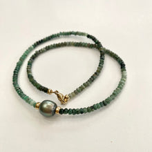 Load image into Gallery viewer, Stunning shaded green Necklace featuring faceted Emerald roundelle beads and a greenish black Tahitian Pearl centerpiece. May birthstone Gift For Her. Crafted with gold filled, the necklace measures 18.5 inches in length