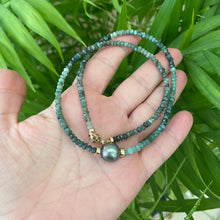 Load image into Gallery viewer, Stunning shaded green Necklace featuring faceted Emerald roundelle beads and a greenish black Tahitian Pearl centerpiece. May birthstone Gift For Her. Crafted with gold filled, the necklace measures 18.5 inches in length