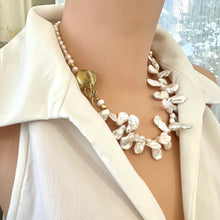 Load image into Gallery viewer, Stunning 19" white Keshi pearls necklace, featuring a unique asymmetrical design that showcases both petal-shaped and nugget pearls with a beautiful golden vine leaf toggle clasp making this necklace not only easy to wear but a striking focal point.