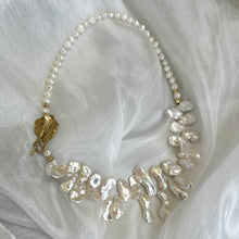 Load image into Gallery viewer, Stunning 19" white Keshi pearls necklace, featuring a unique asymmetrical design that showcases both petal-shaped and nugget pearls with a beautiful golden vine leaf toggle clasp making this necklace not only easy to wear but a striking focal point.