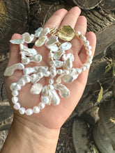 Load image into Gallery viewer, Stunning 19" white Keshi pearls necklace, featuring a unique asymmetrical design that showcases both petal-shaped and nugget pearls with a beautiful golden vine leaf toggle clasp making this necklace not only easy to wear but a striking focal point.