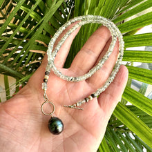 Carica l'immagine nel visualizzatore di Gallery, This necklace features a delicate chain of soft, translucent faceted green Prehnite rondelle beads, beautifully complemented by a striking Tahitian baroque pearl as the centerpiece pending from a cold filled toggle clasp. 18"inches long