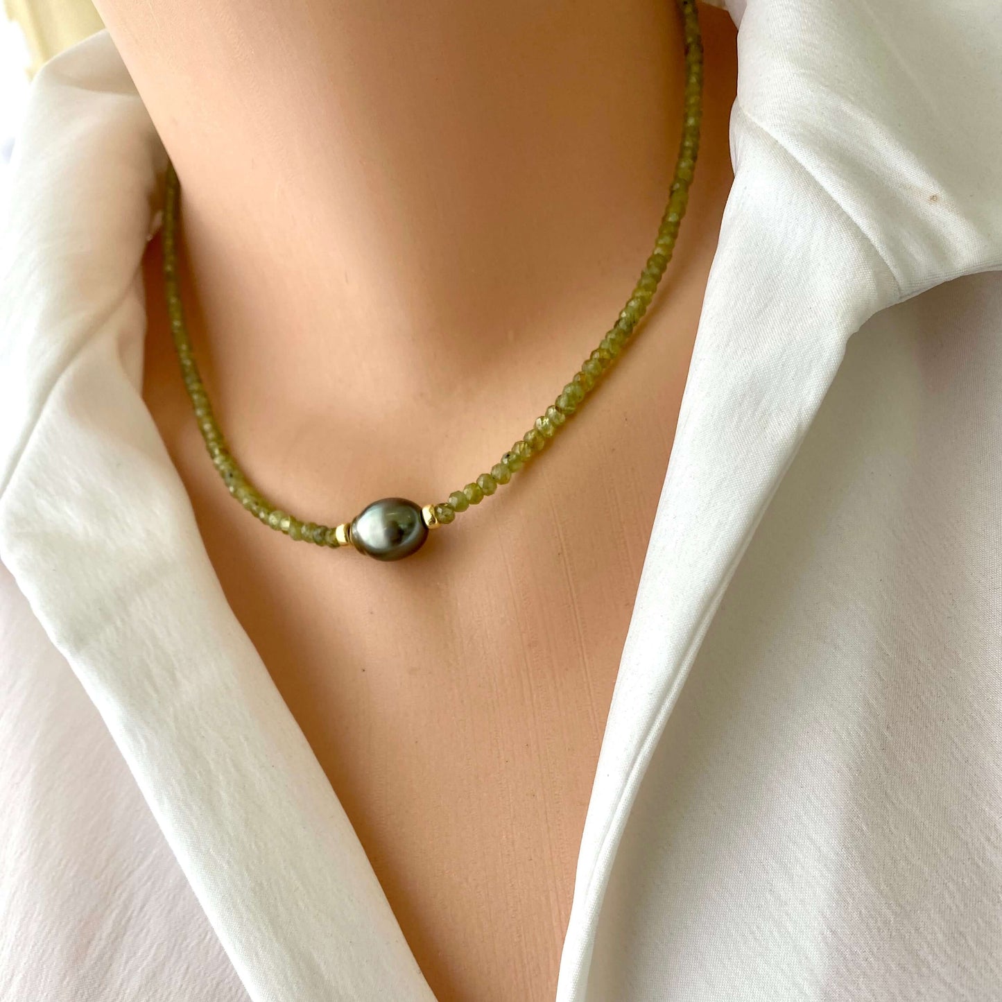 Peridot baroque pearl necklace featuring green Peridot beads and a Tahitian Baroque pearl design.