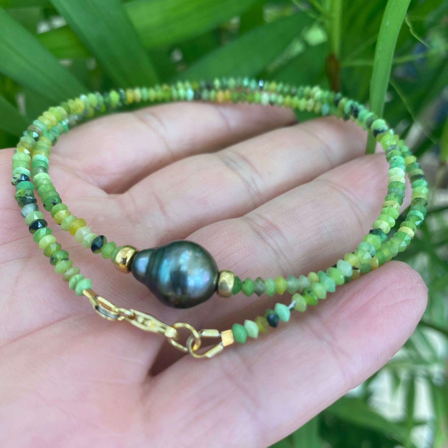 Green chrysoprase baroque pearl necklace featuring Tahitian pearl and gold accents in a vibrant design.