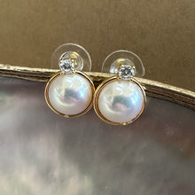 Load image into Gallery viewer, Gold vermeil Mabe Edison pearl stud earrings with CZ accents on beige background