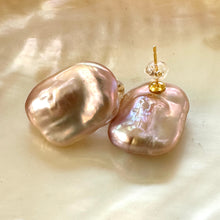 Load image into Gallery viewer, Golden pink rectangle baroque pearl stud earrings close-up on glowing yellow pearl surface, handmade in Canada.