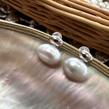 Cargar imagen en el visor de la galería, Silver grey nugget pearl stud earrings shown at an angle on pearl shell, elegant freshwater design handmade in Canada.