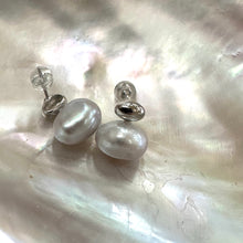 Cargar imagen en el visor de la galería, Silver grey nugget pearl stud earrings displayed on white pearl shell, designed and handmade in Canada.