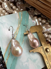 Carica l'immagine nel visualizzatore di Gallery, Lavender Baroque Pearl Earrings – single pearl measured against ruler on turquoise background