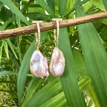 Load image into Gallery viewer, Pink baroque pearl hoop earrings hanging from branch with green leaves, elegant gold vermeil handcrafted jewelry from Canada.