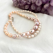 Load image into Gallery viewer, Close-up of Rice Pearl Necklace showing pastel freshwater pearls beside amethyst stone on white cloth.