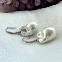 Load image into Gallery viewer, White baroque pearl bridal earrings placed on white cloth table, sterling silver CZ pavé hooks handmade in Canada.
