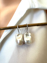 Load image into Gallery viewer, White baroque pearl bridal earrings hanging from branch in front of white blouse mannequin, designed and handmade in Canada.