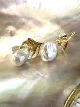 Load image into Gallery viewer, Close-up of handcrafted Baroque Pearl Earrings with oak leaf gold vermeil design displayed on white pearl shell background.