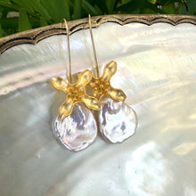 Load image into Gallery viewer, Detailed close-up of white Keshi Pearl Earrings with flower hooks on pearl shell surface.