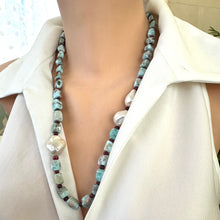 Load image into Gallery viewer, Side angle of larimar ruby and baroque pearl necklace highlighting color contrast