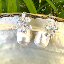 Load image into Gallery viewer, Silver baroque pearl drop earrings on white pearl and green leaf background