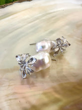 Load image into Gallery viewer, Close-up of silver baroque pearl drop earrings on white pearl background