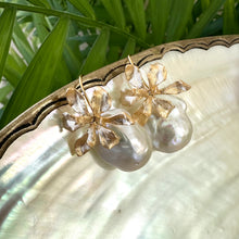 Load image into Gallery viewer, Gold baroque pearl drop earrings with flower design on white and green backdrop