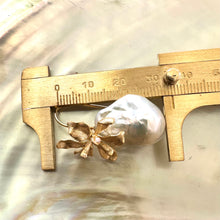 Load image into Gallery viewer, Close-up of gold baroque pearl drop earrings measured with ruler for size