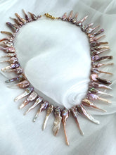 Load image into Gallery viewer, Close-up of pink Biwa pearl necklace showing purplish-pink luster on fabric