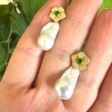 Load image into Gallery viewer, Handmade chrome diopside pearl earrings with removable baroque drops, shown in hand against green leaf