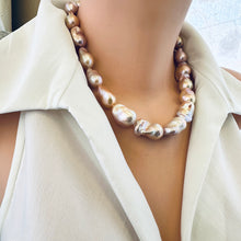 Load image into Gallery viewer, Side angle of golden pink baroque pearl necklace on mannequin, lustrous pearls