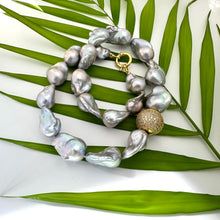 Load image into Gallery viewer, Silver grey baroque pearl necklace close up on green leaf background