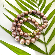 Load image into Gallery viewer, Metallic Edison Pearl Necklace showcasing 12–14mm pearls, handcrafted design, set against green palm leaves.