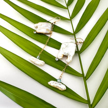 Load image into Gallery viewer, Boho pearl earrings gold filled held against leafy green background — handcrafted square pearl earrings with blue accent by Loulia Pearl Jewelry