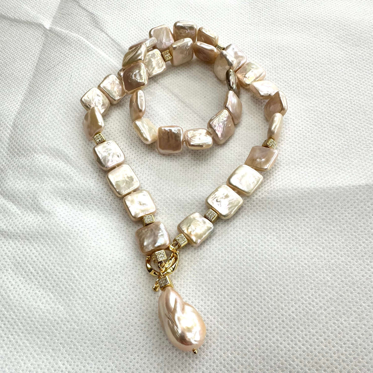 Full view of golden baroque pearl toggle necklace on white backdrop — handcrafted statement jewelry featuring square pearls and gold clasp