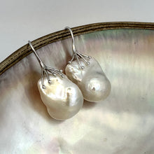 Load image into Gallery viewer, Baroque pearl drop earrings photographed on white pearl background – silver finish