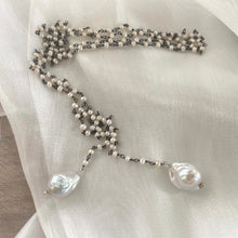 Load image into Gallery viewer, Versatile 40-inch Pearl Lariat Rosary Chain, designed with a stunning black rhodium-plated silver chain and freshwater small pearls for a modern, sophisticated look. Each end of the lariat features a unique white baroque pearl